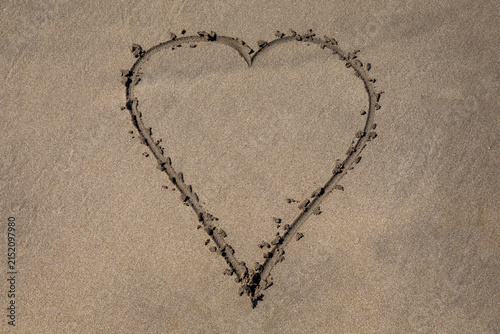 Obraz na plátně Heart Drawn on a Golden Sandy Beach