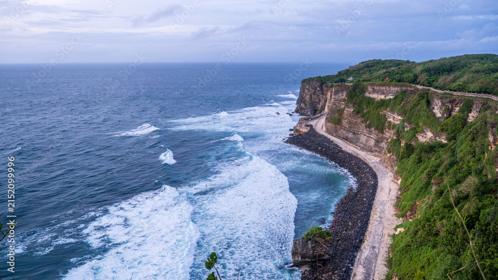 Fototapeta premium Dramatic Coastal Cliffs with Ocean Waves and Curved Path