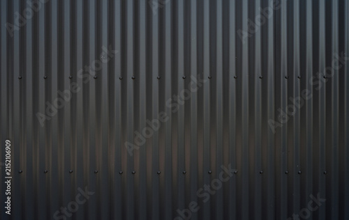 Foto Horizontal close up of black corrugated sheet metal siding with vertical uniform