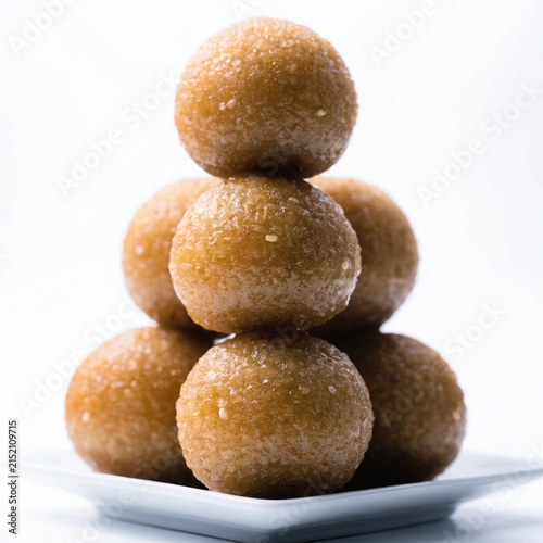 Stacked Traditional Sweet Ladoo on a White Plate and Background