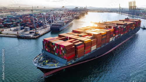 Aerial View of Container Ship Leaving Busy Cargo Port for Global Shipping and International Trade