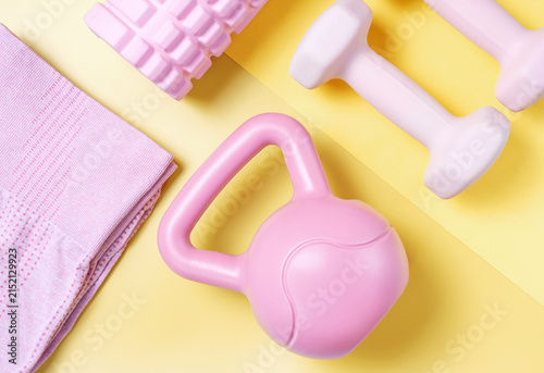 Set of sports accessories on yellow background top view.