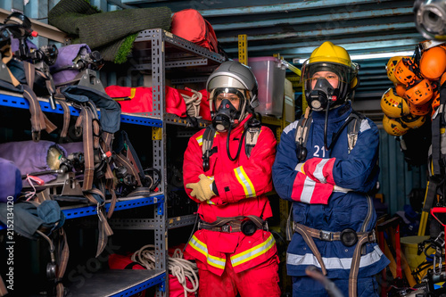 Obraz na płótnie Brave male firefighters in full protective gear, helmet, and smoke mask respirat