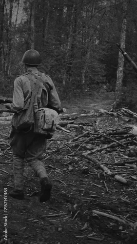 Soviet soldiers marching in slow motion along a forest road in WWII