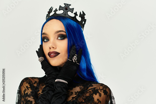 Photography Gothic queen with blue hair and dark elegance poses for Halloween celebration