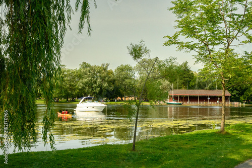 Konstfotografi Cabin cruiser anchored and sea kayakers paddling on the Toronto Islands' Long Po