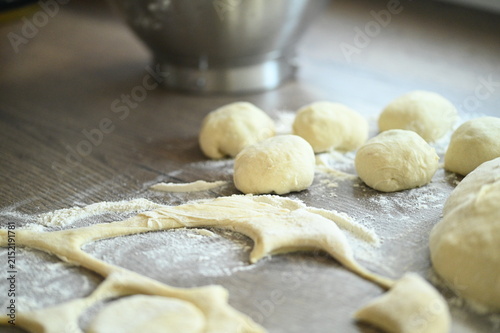 Konstfotografi Preparation of homemade yeast dumplings on a rustic wooden table, filled yeast d