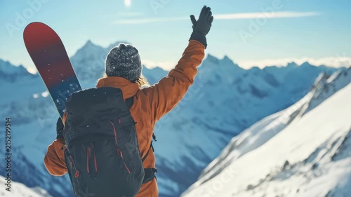Woman in bright orange jacket and hat skiing; elated expression on face