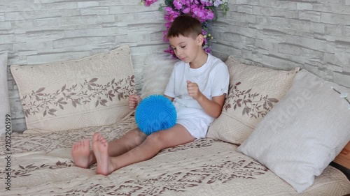 Cute preschool child, boy, playing with toys in a sunny living room