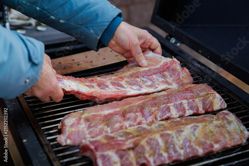 Bild auf Leinwand Flavors mingle at a backyard barbecue with sizzling ribs and smoky goodness