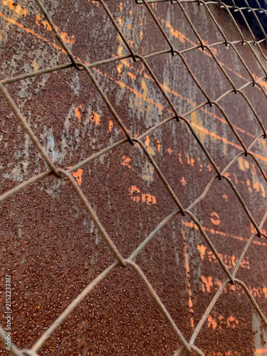 Obraz na plátne Rusted Chain Link Fence Over Weathered Metal Surface
