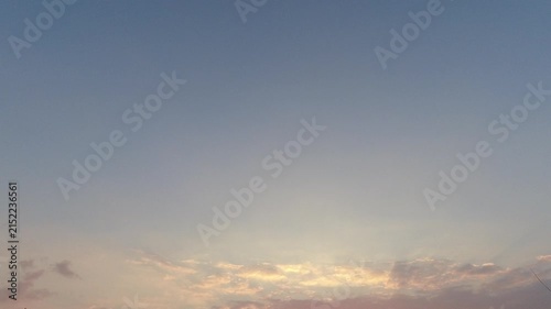 Time-lapse of a soft sunset or sunrise sky with gentle clouds at the bottom. Ample negative space for text and titles. Peaceful nature background.
