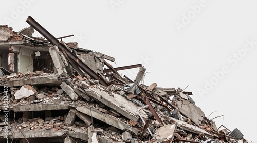 collapsed and destroyed remains of wrecked building on white background