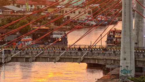 A view of Banjarmasin city and the Alalak River Bridge (or Basit Handil Bakti Bridge) in the sunset