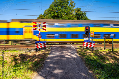 Double Decker Intercity Train passing an Unguarded Railway Crossing in Heiloo, North Holland, Netherlands