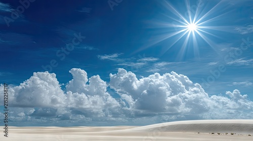 Bright sun over white clouds and desert sand dunes.