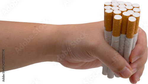 A hand is tightly gripping a handful of cigarettes with white filters and orange-yellow bodies, set against a transparent background.