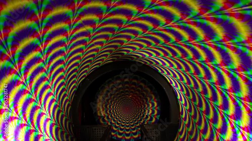 Vortex tunnel - rotating psychedelic light tunnel at a funhouse attraction, creating an optical illusion and vertigo