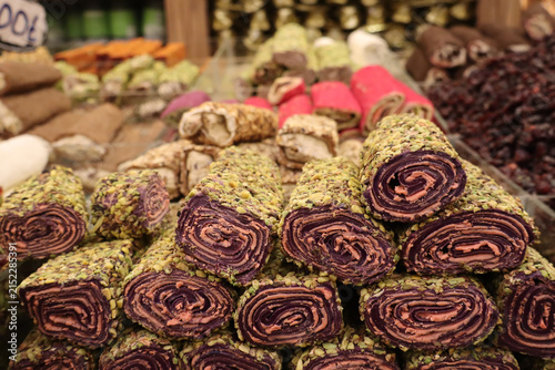 Obraz na płótnie Colorful Rolled Turkish Delight Coated with Pistachios at Local Market