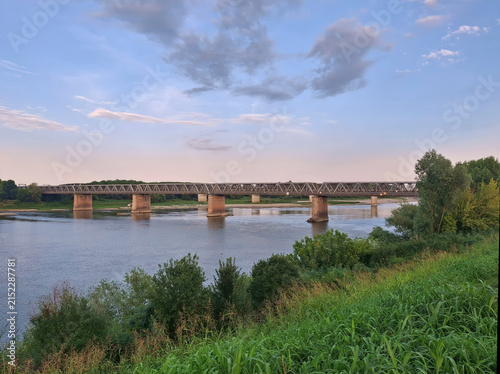 scenic view of a bridge over the Po River at sunset