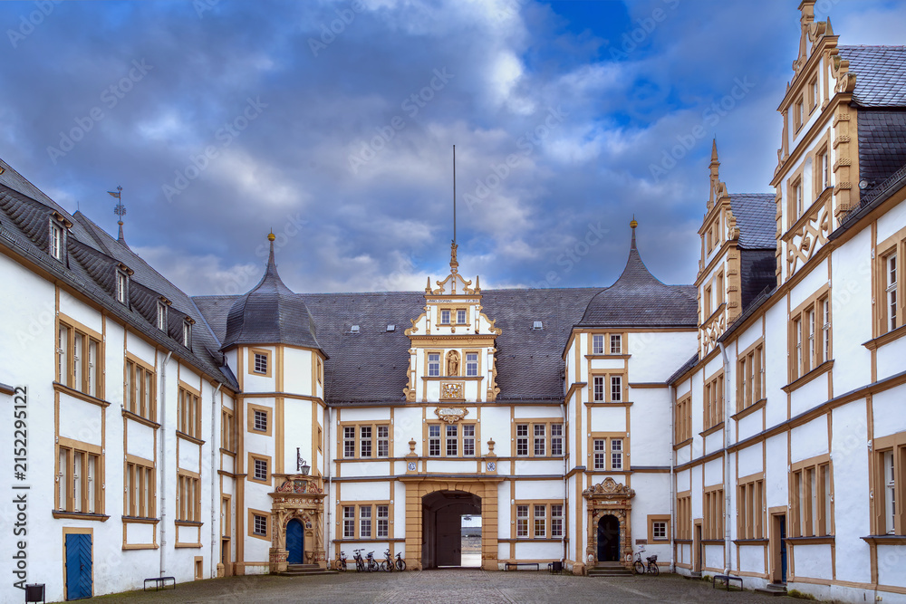 Obraz premium Courtyard of Neuhaus Castle in Paderborn, Germany, inner view. Historic renaissance palace architecture under cloudy winter sky