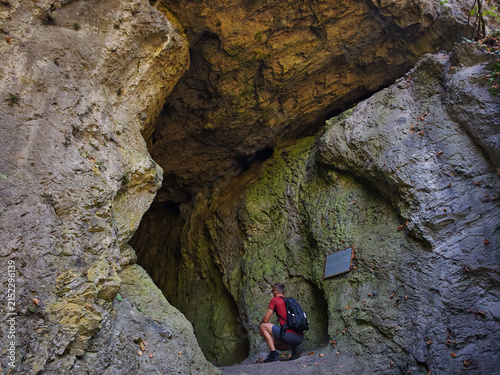 Cuadro en lienzo Hiker exploring the large upper entrance of Herman Otto Cave in the rocky Szinva Gorge near Miskolc, Bükk Mountains, Hungary