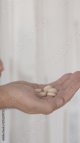 Close up of male hands pouring pills from bottle prescription medicine and healthcare routine