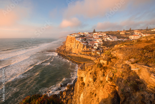 Coastal village of Azenhas do Mar built on a cliff over the Atlantic Ocean at sunset, Sintra, Portugal