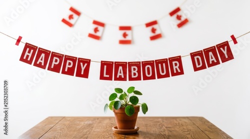 Happy Labour Day red paper banner hanging over wooden table