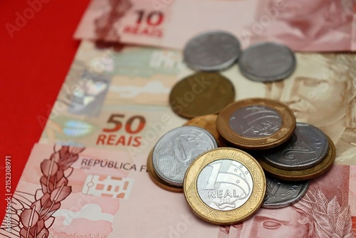 Brazilian Real banknotes and coins. Brazilian money, inflation, economy, salary, and personal finance concept.