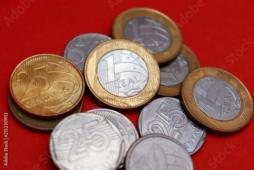 Brazilian coins on a red background. Brazilian economy concept.