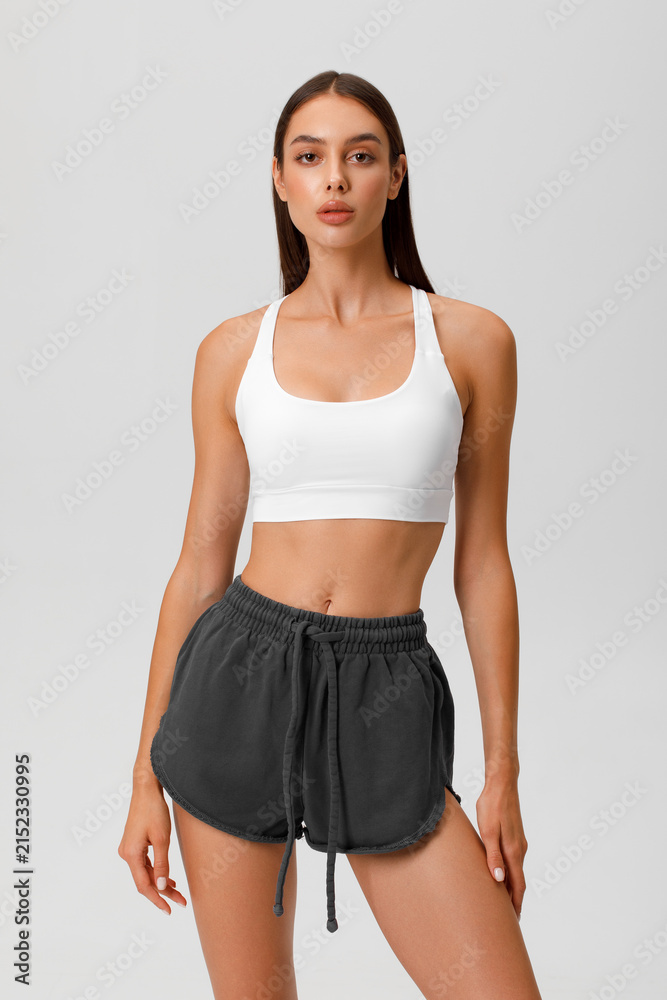 Fototapeta premium Fitness woman. Athletic girl on the gray background