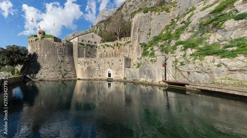 Old Kotor city wall and medieval fortress with water reflection, Montenegro