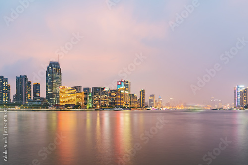Modern urban architecture, road traffic, and Huangpu River night view in Lujiazui, Pudong, Shanghai, China
