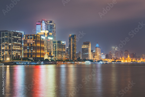 Modern urban architecture, road traffic, and Huangpu River night view in Lujiazui, Pudong, Shanghai, China