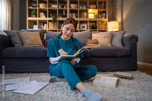 Obraz na płótnie Medical student studying healthcare in apartment living room