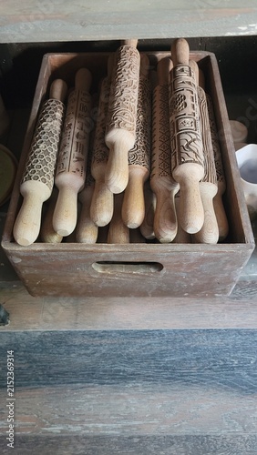 Collection of textured ceramic rolling pins and clay tools in pottery workshop