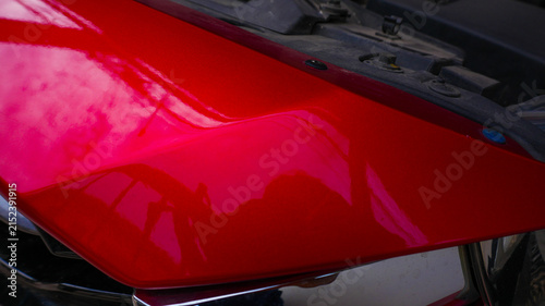 Close Up of Red Car Body and Chrome Front Grille Detail