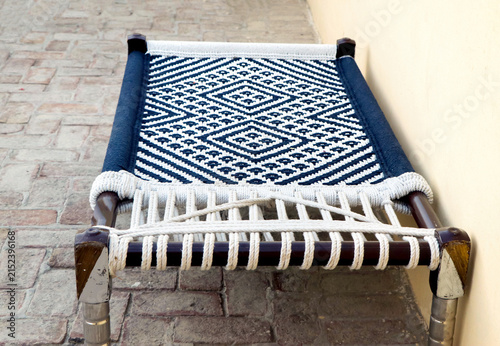 Traditional Indian Woven Bed Charpai on Paved Ground