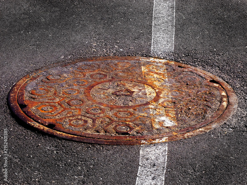 Manhole Cover Man Hole Iron Round Cover Worn and Rusty with White Painted Line Slanted and Off Kilter