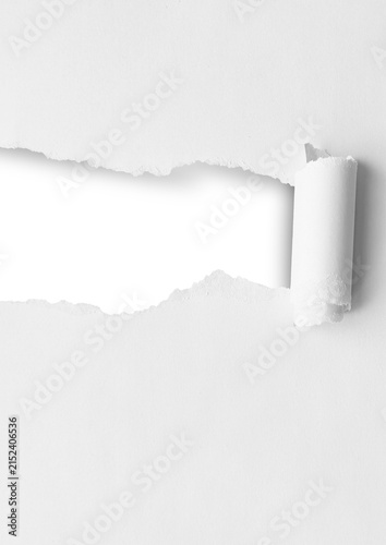 фотографія Torn paper sheet with a ripped hole in the middle