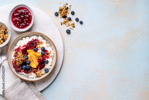 Healthy summer breakfast with cottage cheese, granola and fresh berries and homemade berry jam