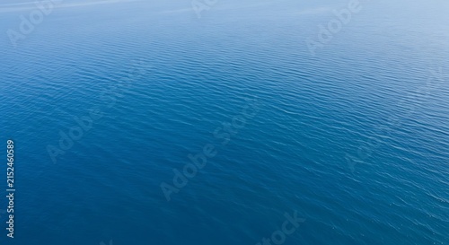 Abstract aerial view of rippling blue water surface with subtle wave patterns