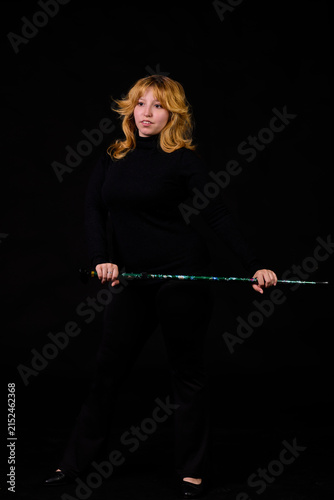 Canvas Print Blonde woman in black turtleneck holding magician wand