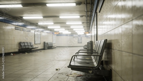 Empty subway platform with rows of worn black seats along tiled walls fluorescent ceiling lights scattered litter dirty floor underground transit station urban infrastructure public transportation com