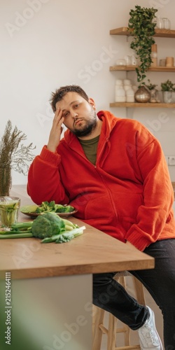 Frustrated man struggling with diet and healthy food