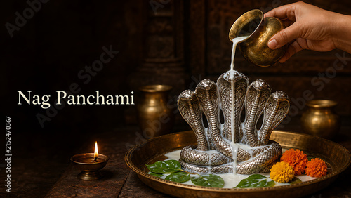 Devotee hand gently pouring fresh white milk over a beautiful multi headed metallic cobra statue honoring mahadev during the nag panchami festival