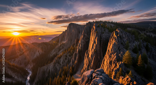 Majestic mountain range bathed in golden hour sunlight with dramatic sky clouds and pine trees