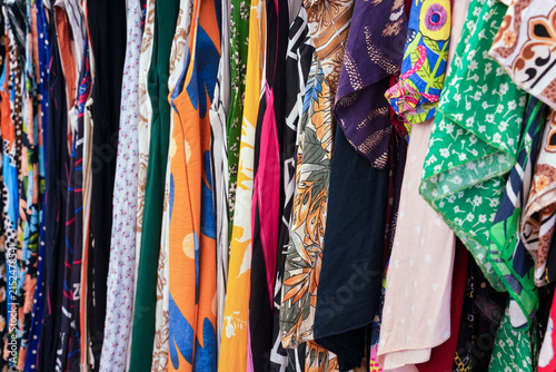 Various dress and t shirt on display at street market, closeup detail