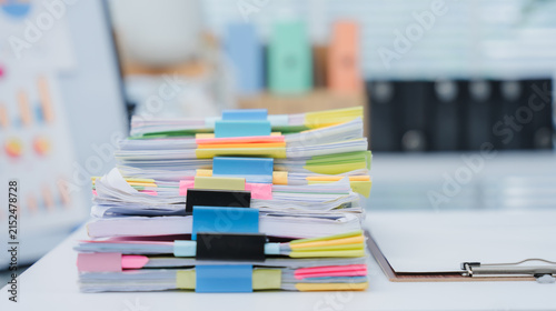 Cuadro en lienzo Workplace Documentation: A close-up shot of an office worker in a tailored blue blazer, meticulously reviewing a stack of documents